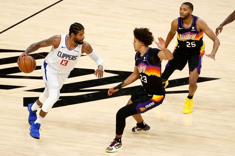 Paul George #13 handles the ball against Cameron Johnson #23