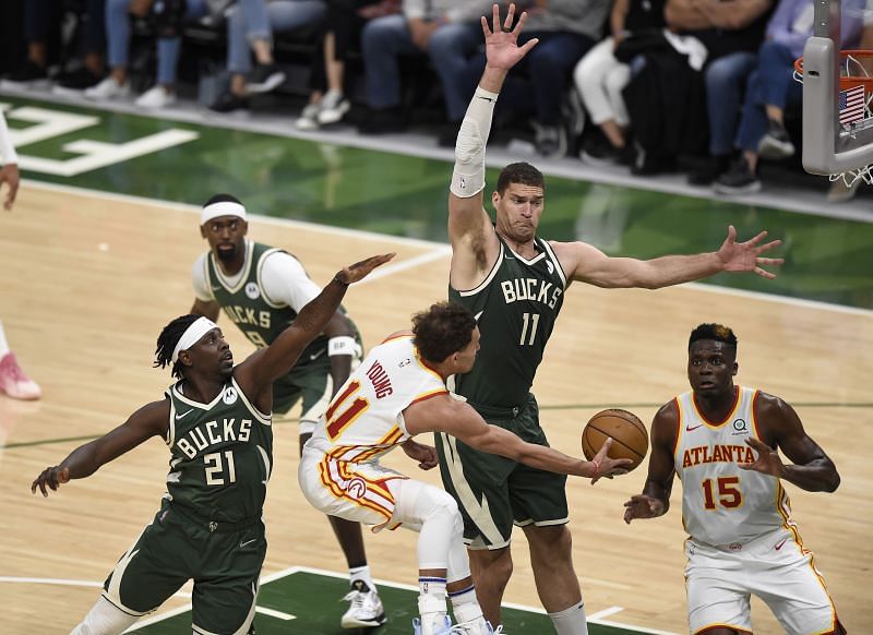 Brook Lopez #11 of the Bucks defends against Trae Young #11 of the Hawks