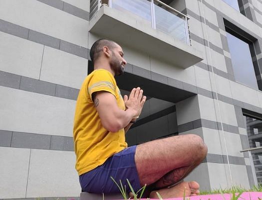 Shikhar Dhawan performs yoga.