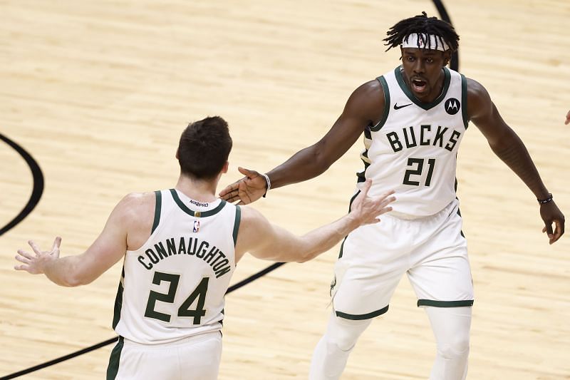 Jrue Holiday #21 of the Milwaukee Bucks celebrates with Pat Connaughton #24