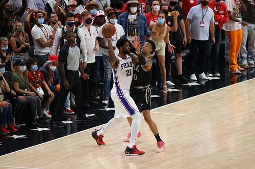 Joel Embiid of the Philadelphia 76ers vies with John Collins of the Atlanta Hawks