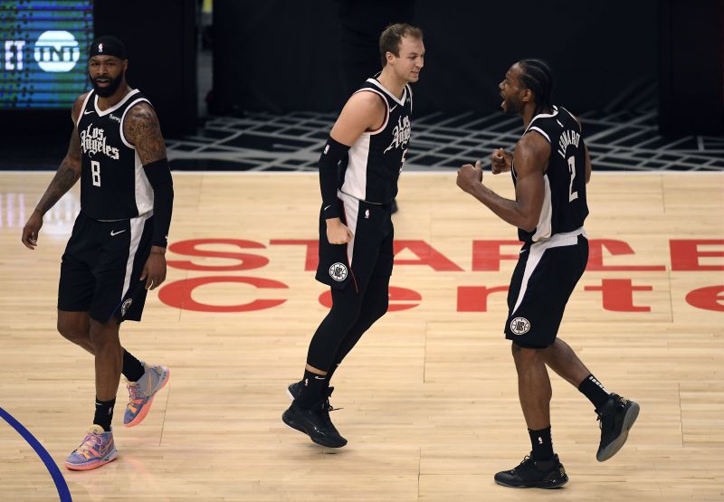 Kawhi Leonard #2 and Marcus Morris Sr. #8 celebrate a three-point basket by Luke Kennard #5.