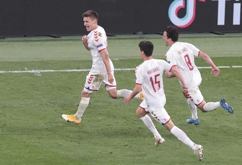 Denmark rejoice after scoring one of their four goals against Russia.