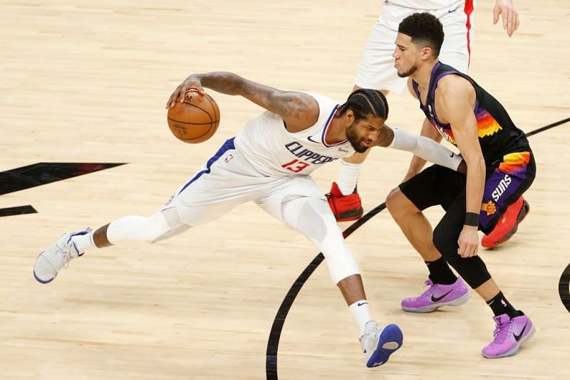 Paul George is guarded by Devin Booker