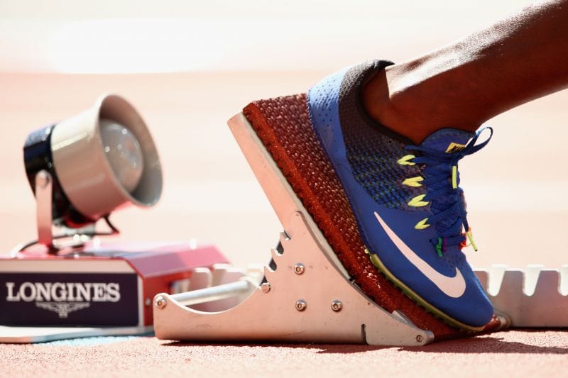 How are race timings measured in Athletics events?