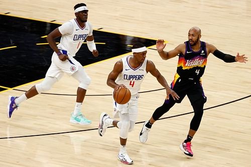 Rajon Rondo #4 of the LA Clippers moves the ball past Jevon Carter #4 of the Phoenix Suns