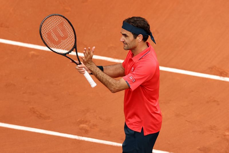 Roger Federer celebrates after reaching the third round at Roland Garros