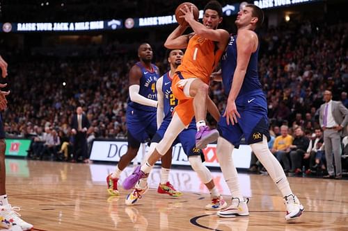 Phoenix Suns' Devin Booker, #1, attempting a pass