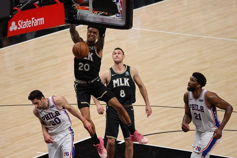 John Collins #20 of the Atlanta Hawks dunks against Furkan Korkmaz #30 and Joel Embiid #21 of the Philadelphia 76ers during the second half of Game 5 of the Eastern Conference Semifinals