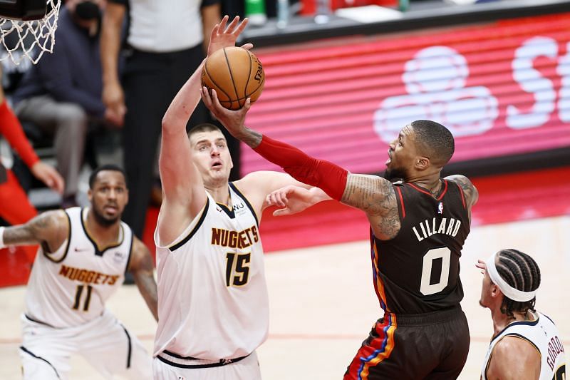 The Portland Trail Blazers&#039; Damian Lillard #0 shoots against the Denver Nuggets&#039; Nikola Jokic #15