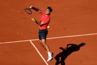 Roger Federer hits a smash