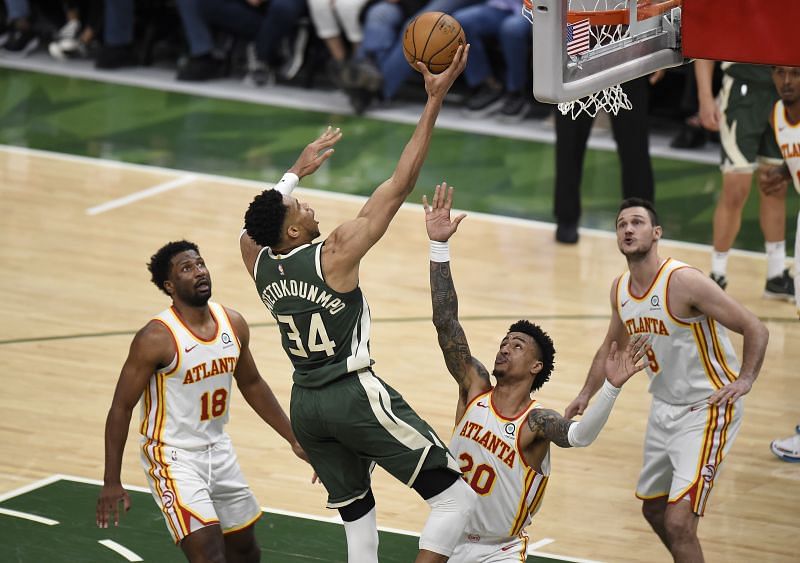 Giannis Antetokounmpo #34 shoots against John Collins #20