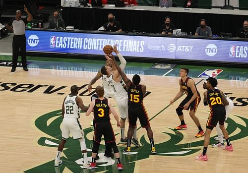 Brook Lopez #11 of the Milwaukee Bucks tips off against Clint Capela #15 of the Atlanta Hawks