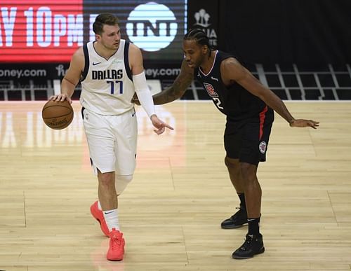 Luka Doncic #77 of the Dallas Mavericks and Kawhi Leonard of the LA Clippers