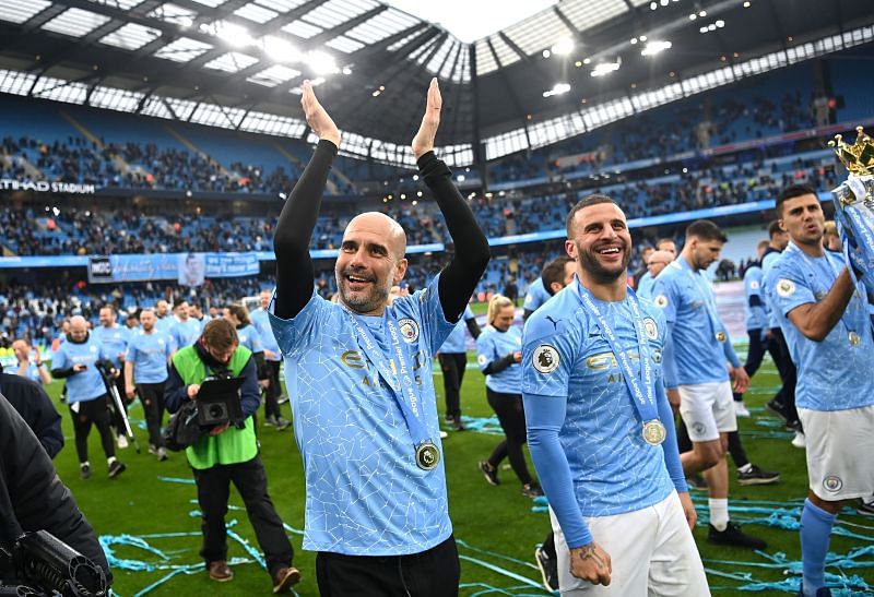 Manchester City&#039;s Pep Guardiola and Kyle Walker celebrate after winning the 2020/21 Premier League