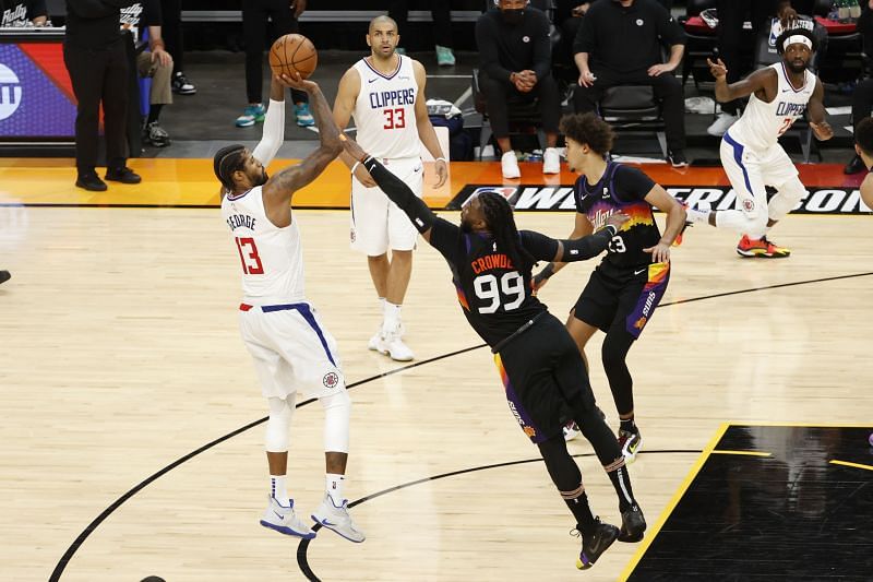 Paul George #13 makes a jump shot ahead of Jae Crowder #99