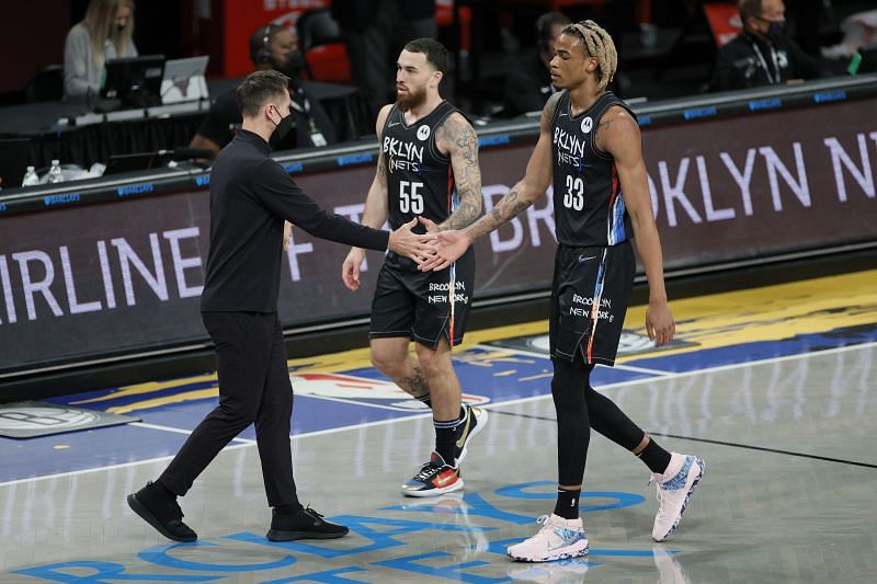 Head coach Steve Nash of the Brooklyn Nets high-fives Mike James (#55) and Nicolas Claxton (#33)