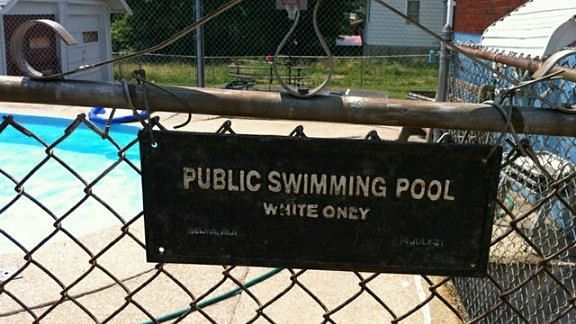 &#039;White Only&#039; signboard on the gate of a public swimming pool dated 14th July 1931