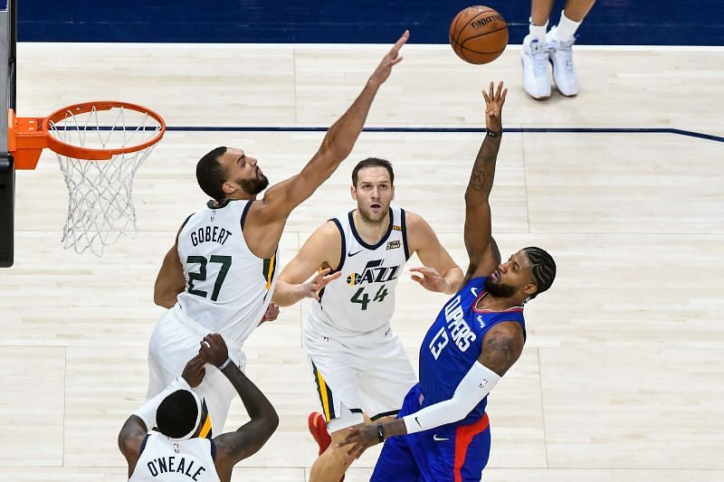 Paul George #13 attempts a shot over Rudy Gobert #27.