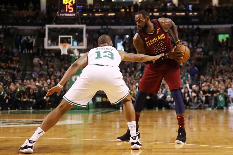 LeBron James #23 is defended by Marcus Morris #13.