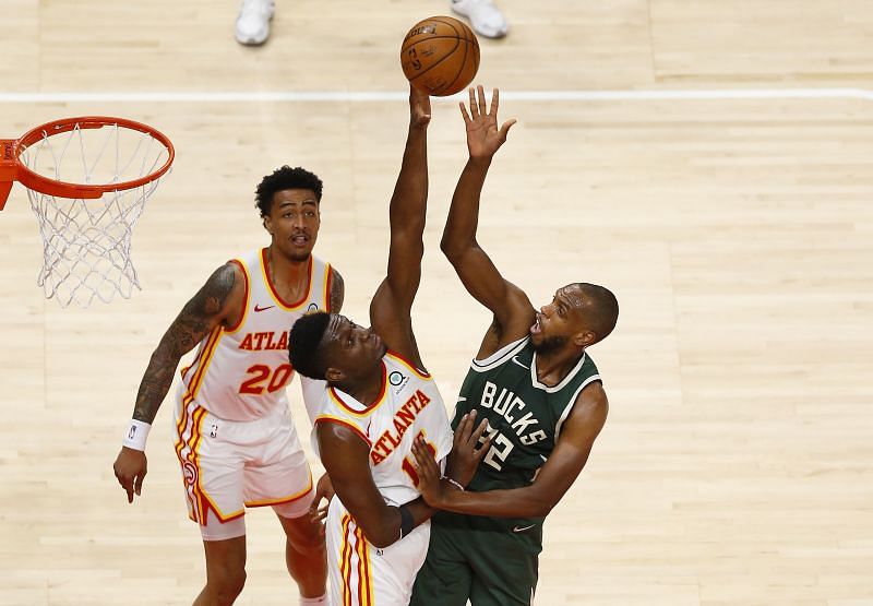 Khris Middleton #22 shoots over center Clint Capela #15