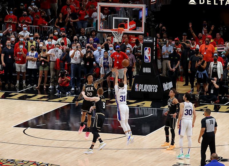 Seth Curry #31 of the Philadelphia 76ers attempts a game-tying three-point basket against John Collins #20 and Kevin Huerter #3 of the Atlanta Hawks