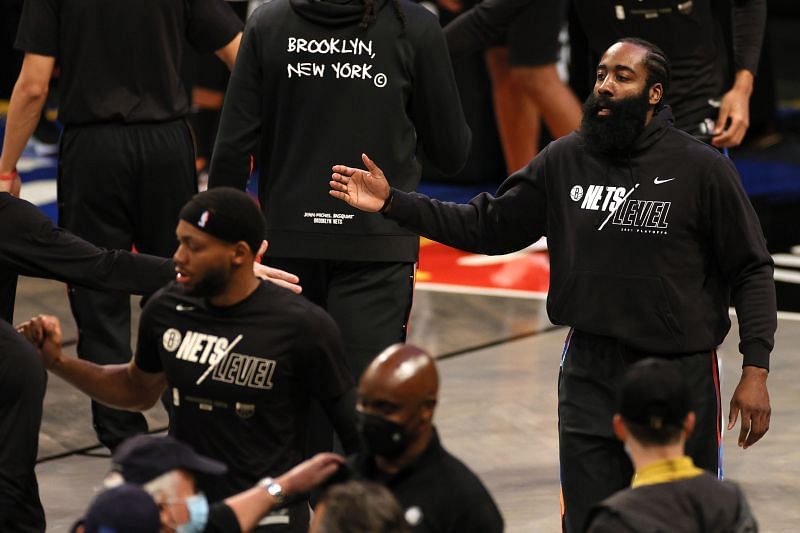 James Harden #13 high-fives teammates while warming up.