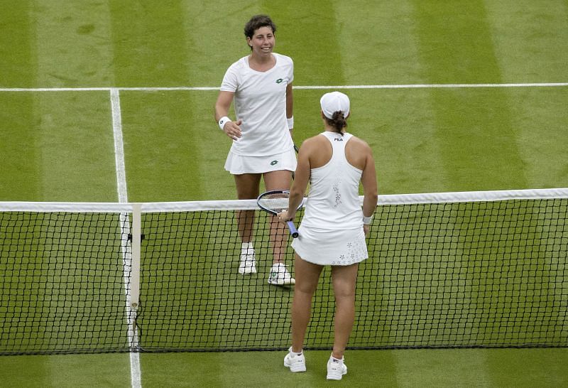 Carla Suarez Navarro (facing the camera) and Ashleigh Barty at the net after the match