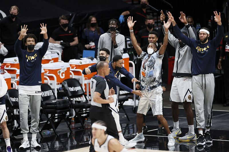 The Denver Nuggets bench reacts after a three point basket.