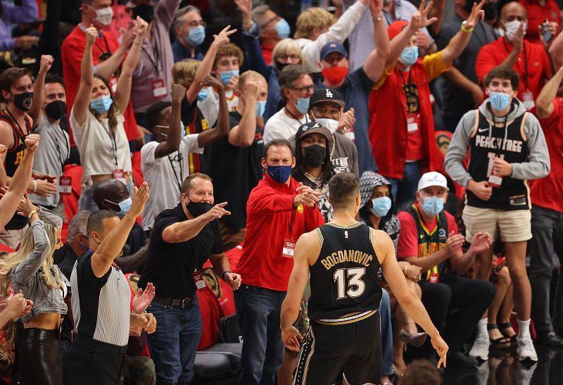 Fans react after Bogdan Bogdanovic (#13) of the Atlanta Hawks hit a three-point basket.