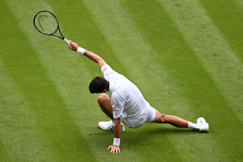 Novak Djokovic reacts after taking a tumble on the grass at Centre Court