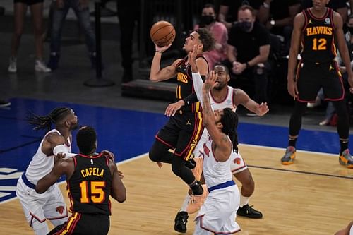 Trae Young, center, drives to the basket during the first half of Game 1