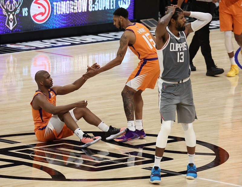 Chris Paul is helped up by teammate Cameron Payne after being fouled by Paul George