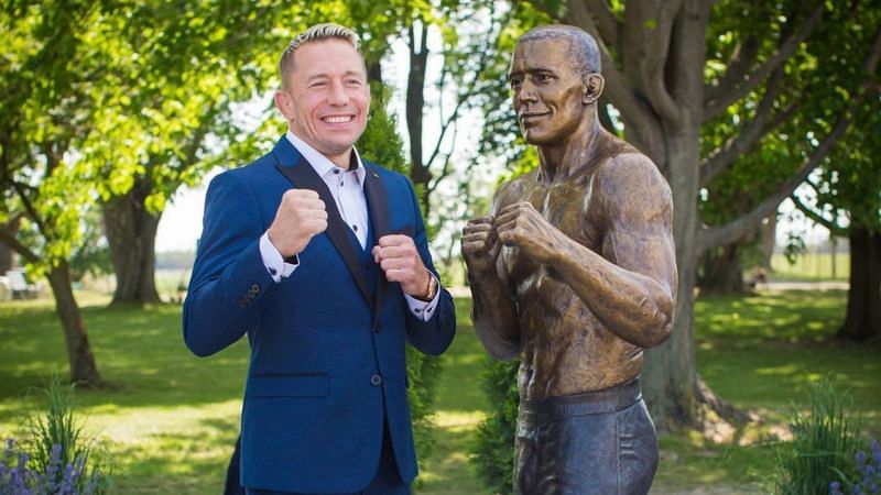 Georges St-Pierre strikes a pose with his statue. [Photo credit: @georgesstpierre on Instagram]