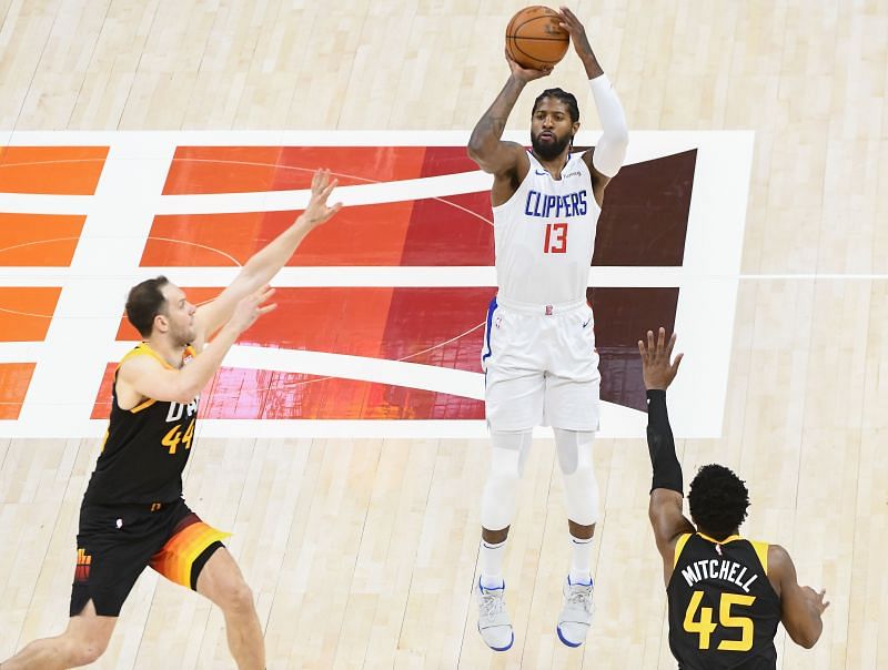 Paul George #13 shoots against Donovan Mitchell #45 and Bojan Bogdanovic #44 in the NBA Playoffs