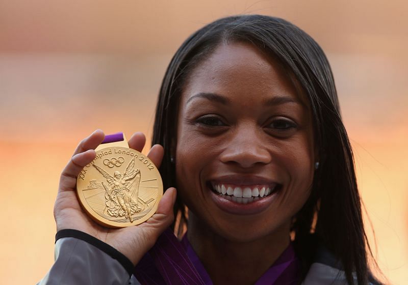 Allyson Felix poses with her gold medal at the 2012 Olympics
