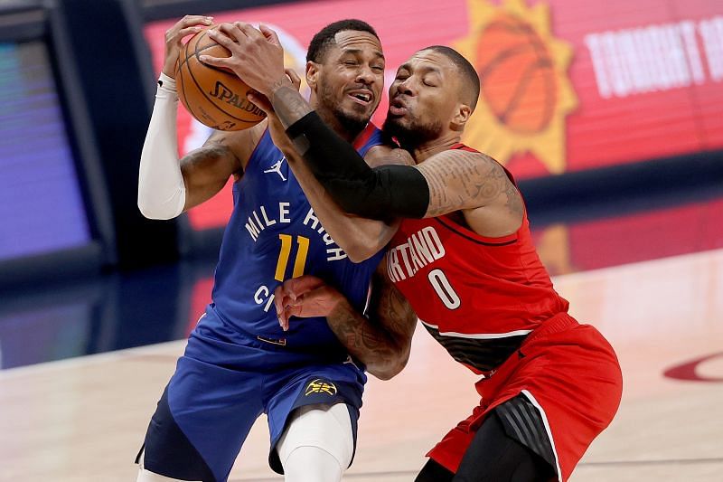 Monte Morris and Damian Lillard tussle for the ball