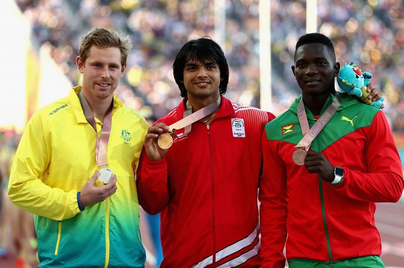 Neeraj Chopra (centre) at the 2018 Commonwealth Games with Anderson Peters (right)