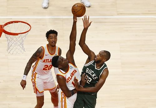 Forward Khris Middleton #22 of the Bucks shoots over center Clint Capela #15 of the Hawks