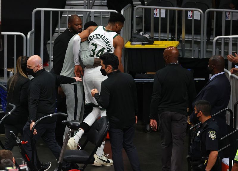 Giannis Antetokounmpo of the Milwaukee Bucks gets escorted to the locker room