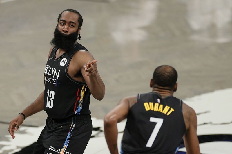 James Harden (#13) reacts with Kevin Durant (#7) of the Brooklyn Nets