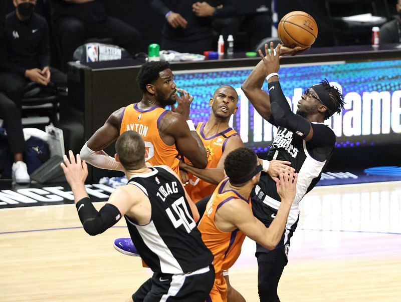 Reggie Jackson (#1) scores against Devin Booker (#1), Deandre Ayton (#22) and Chris Paul (#3).