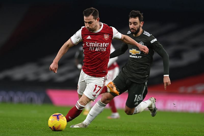 Cedric Soares of Arsenal vies with Manchester United&#039;s Bruno Fernandes in a Premier League game