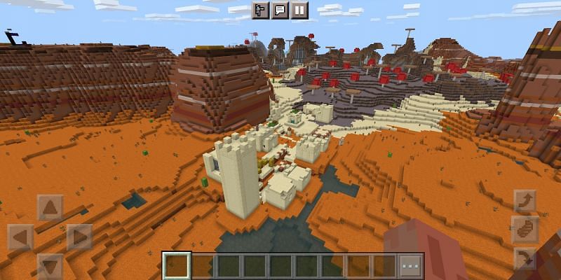 A village surrounded by three biomes (Image via Minecrqft)