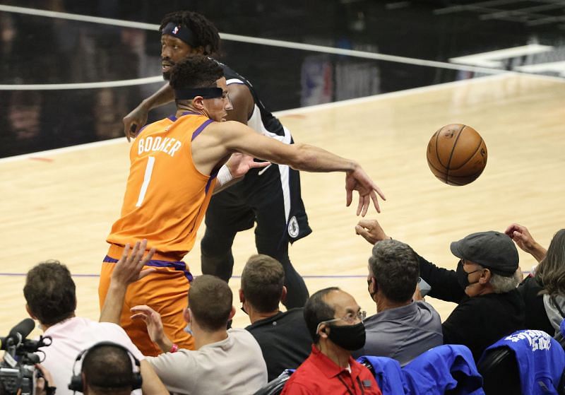 Devin Booker #1 looses the ball against Patrick Beverley #21.