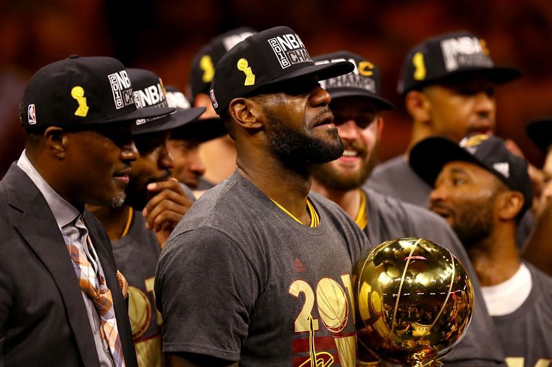 LeBron James #23 of the Cleveland Cavaliers holds the Larry O&#039;Brien Championship Trophy after defeating the Golden State Warriors 93-89 in Game 7 of the 2016 NBA Finals.