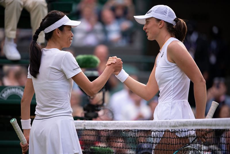 Hsieh Su-wei (L) and Iga Swiatek shake hands after their match