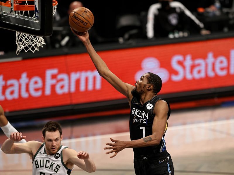 Kevin Durant #7 heads for the net as Pat Connaughton #24 looks on