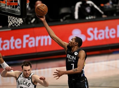 Kevin Durant #7 heads for the net as Pat Connaughton #24 looks on