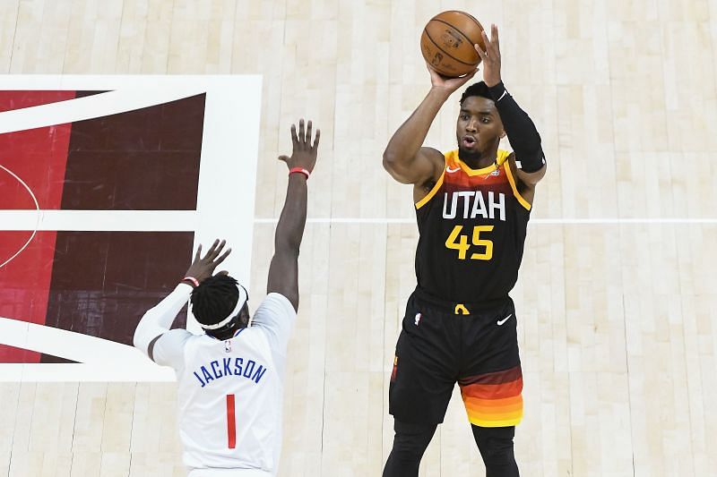 Donovan Mitchell #45 shoots over Reggie Jackson #1